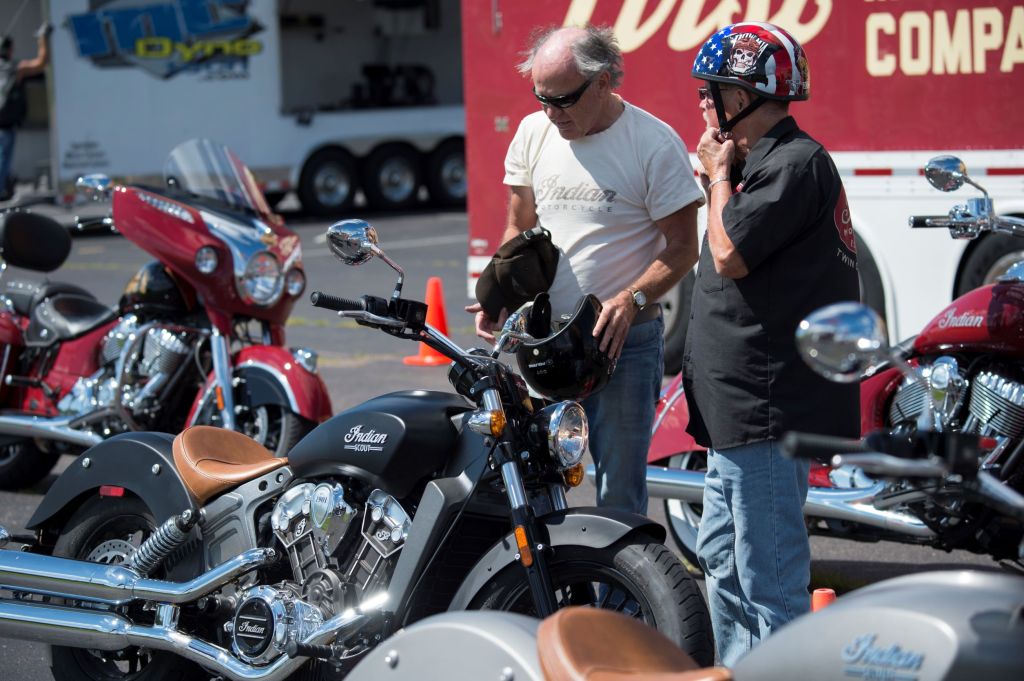 Two riders look at the motorcycles for sale at an Indian dealership