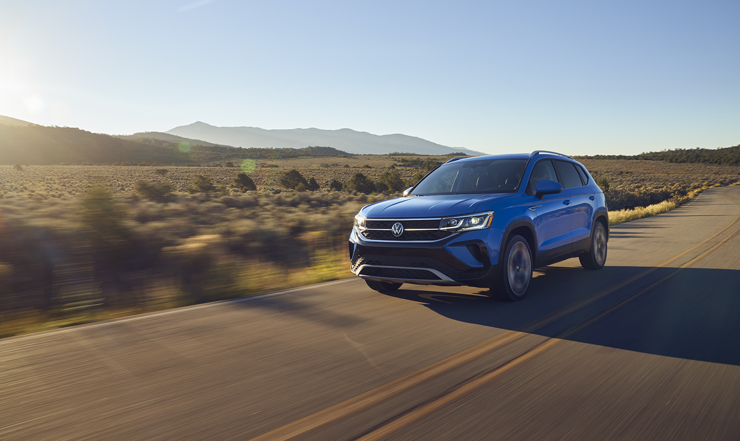 The 2022 Volkswagen Taos driving on the road