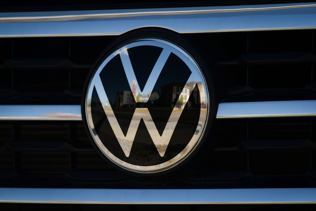 A Volkswagen logo on the grille of a car.