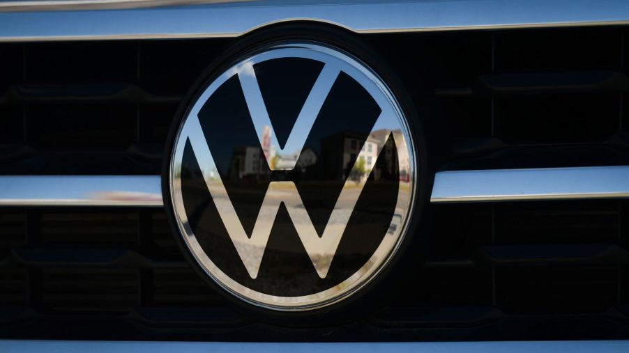A Volkswagen logo on the grille of a car.