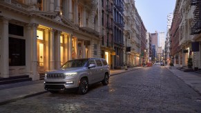 This is a publicity photo of a 2022 Grand Wagoneer parked in the city. The new Luxury SUV did surpisingly well in a head-to-head with the Rolls Royce Cullinan. | Stellantis