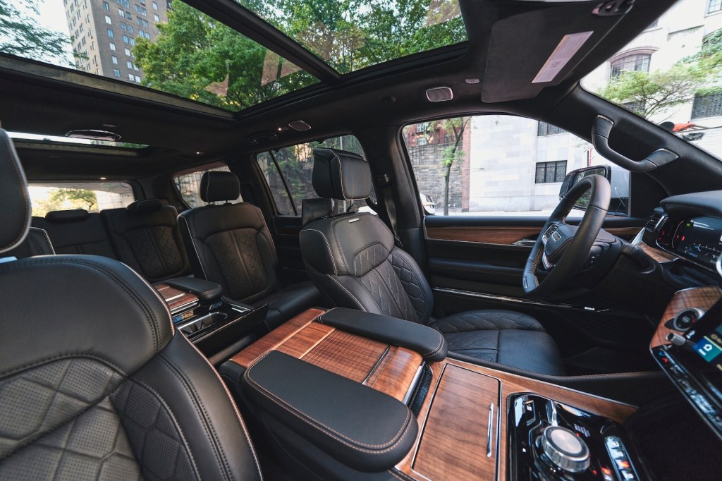 This is a publicity shot of the interior of a 2022 Jeep Grand Wagoneer. When Motor Trend reviewed the new luxury SUV, they compared it favorably to the Rolls Royce Cullinan | Stellantis