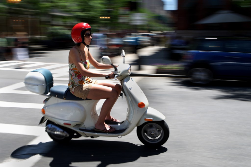 Woman Riding On Moped