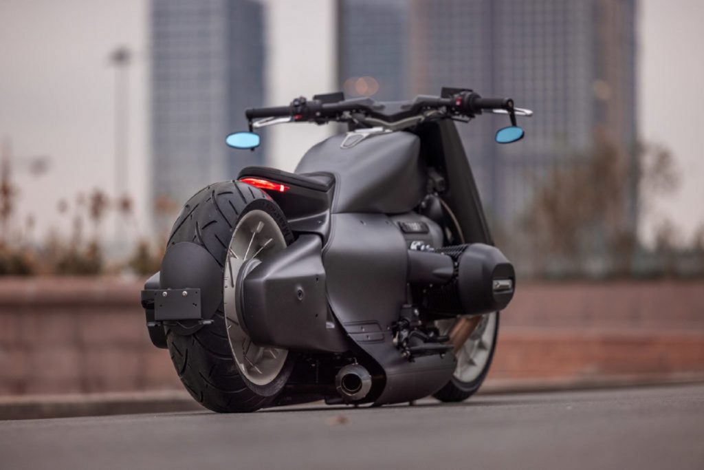 The rear 3/4 view of Zillers Garage's custom gray carbon-fiber-bodied BMW R 18 on a city street