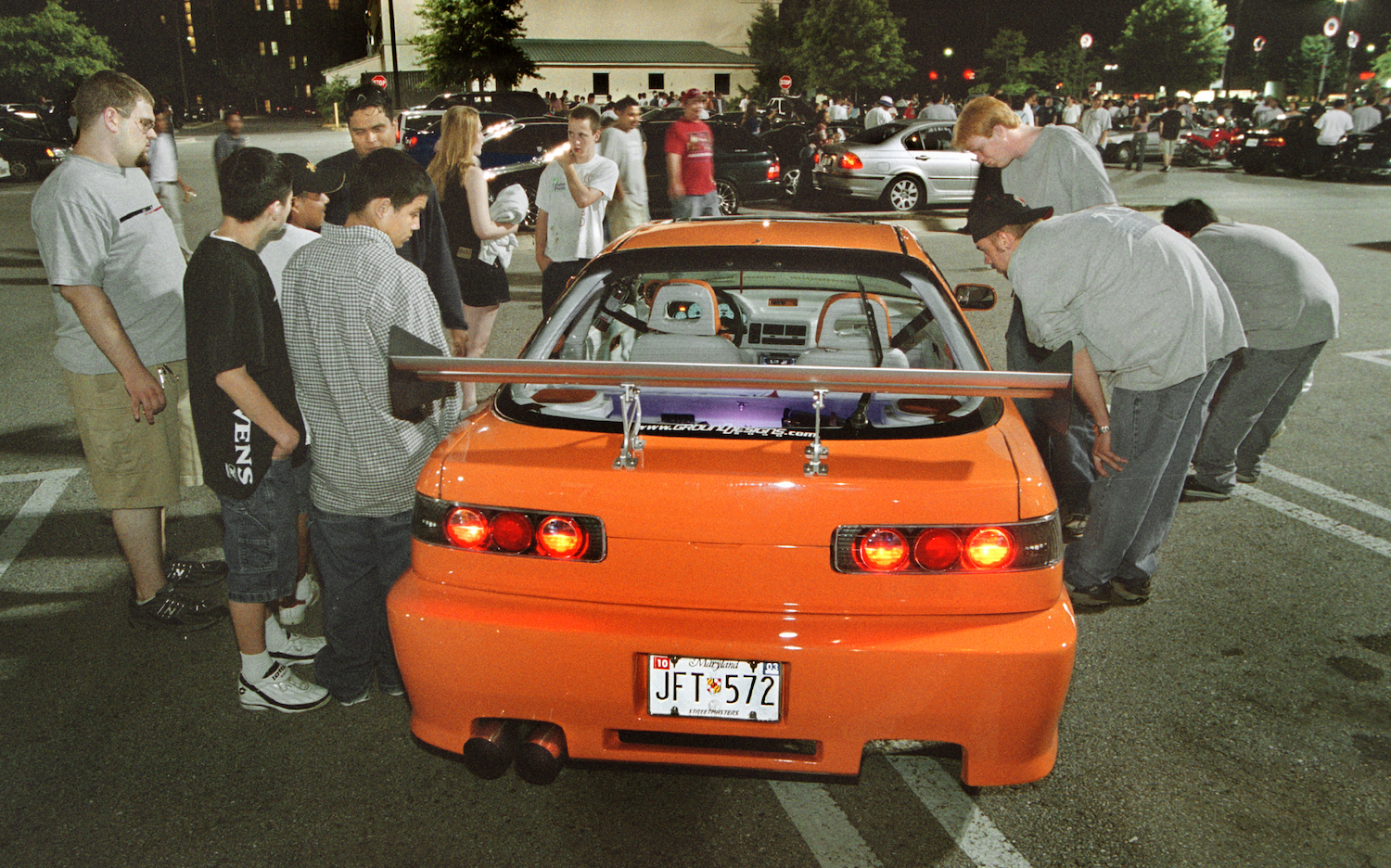 Acura Integra surrounded by kids