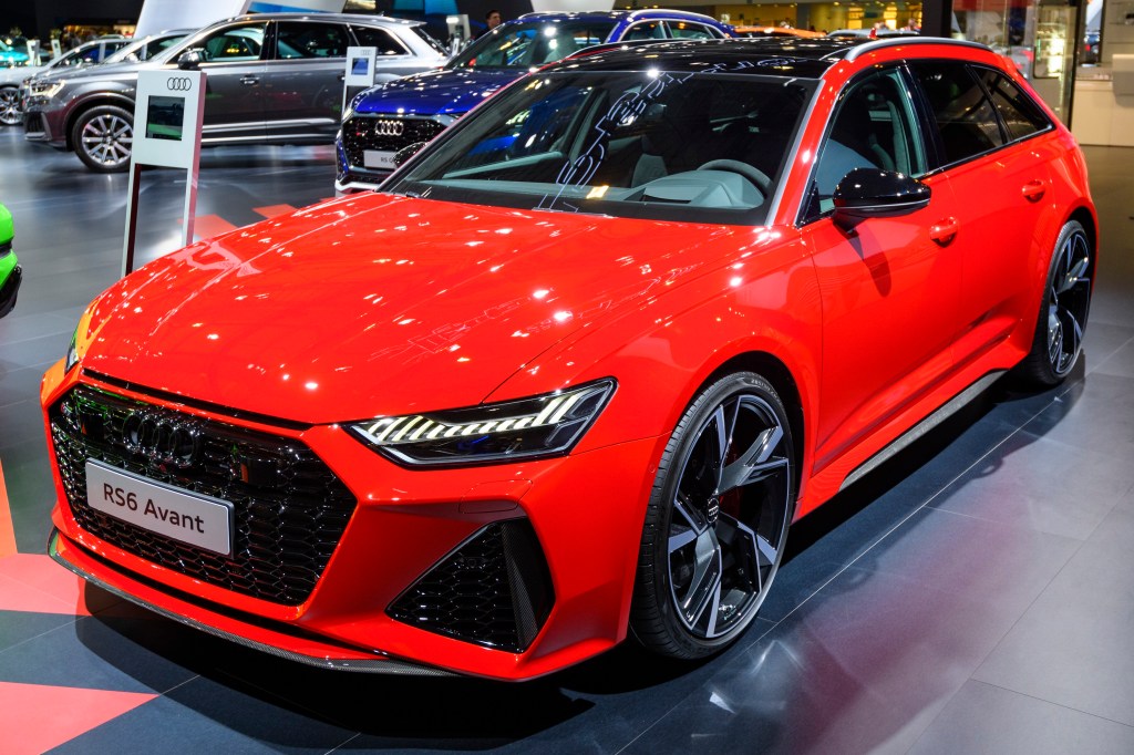 A red Audi RS6 Avant shot from the front 3/4 at an auto show
