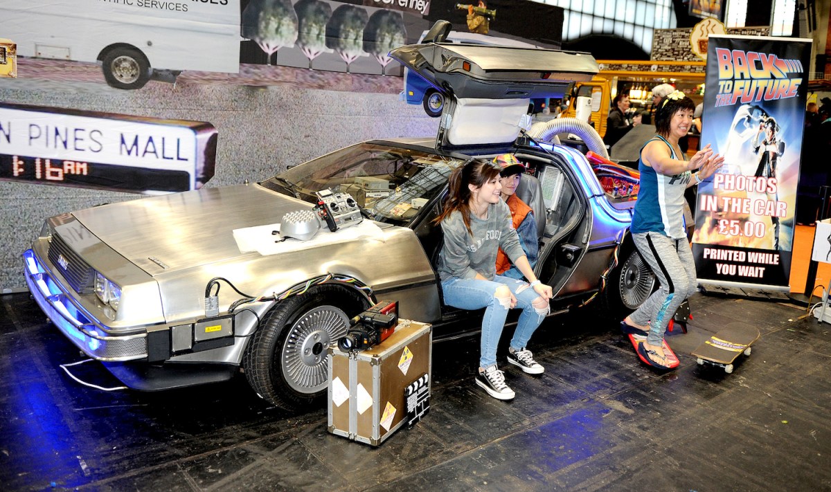 Fans pose next to a Back to the Future DeLorean in England