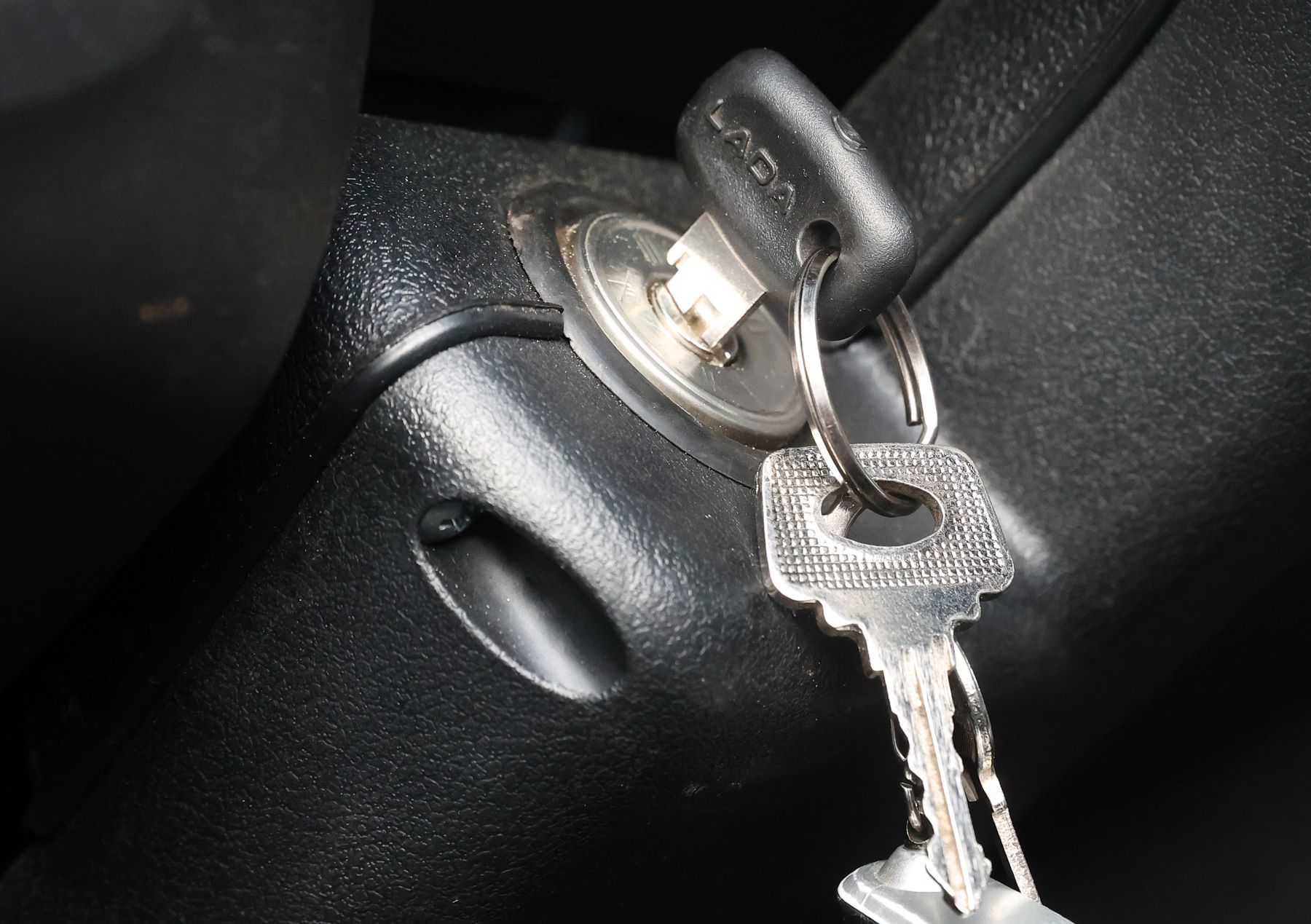 A car key placed in a vehicle's ignition