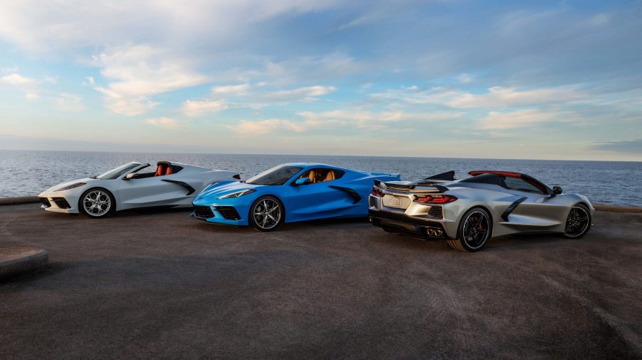 A trio of Chevrolet Corvette models shot at the 3/4 angle by the sea