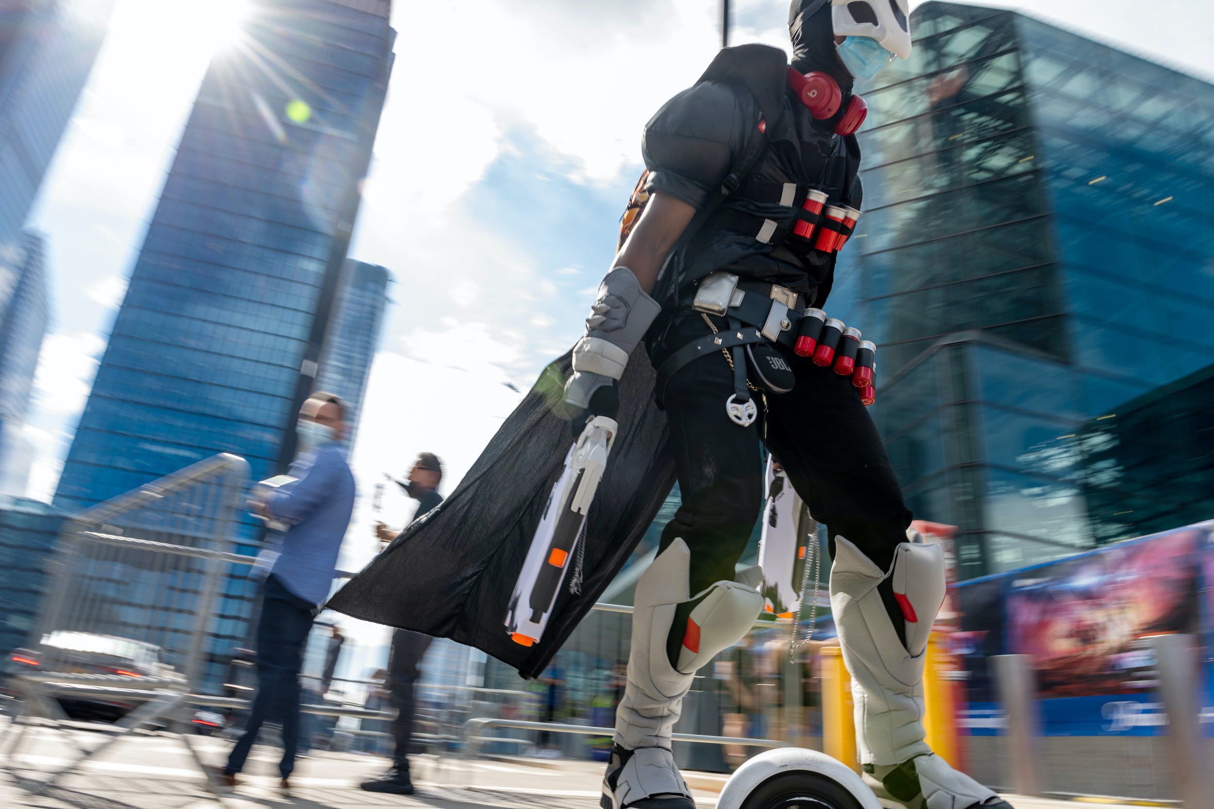 A cosplayer dressed as Reaper rides on a one wheel electric scoote
