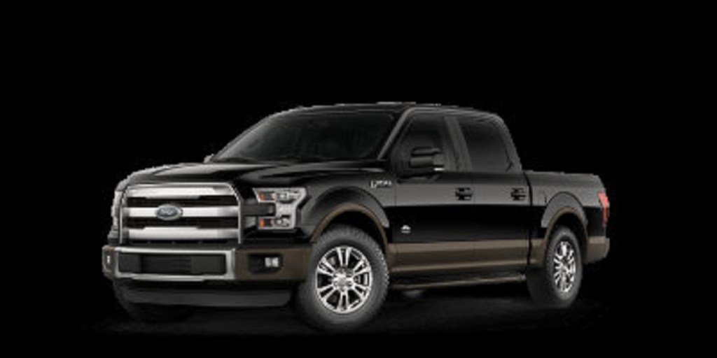 A black 2021 Ford F-150 crew cab truck against a black background.