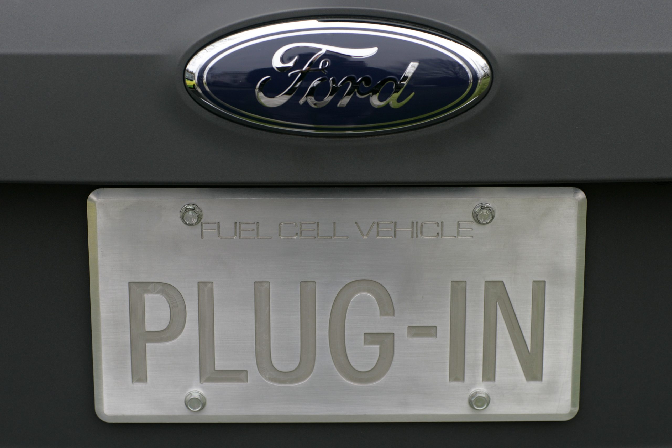 A license plate on a Ford test vehicle that reads "plug-in"
