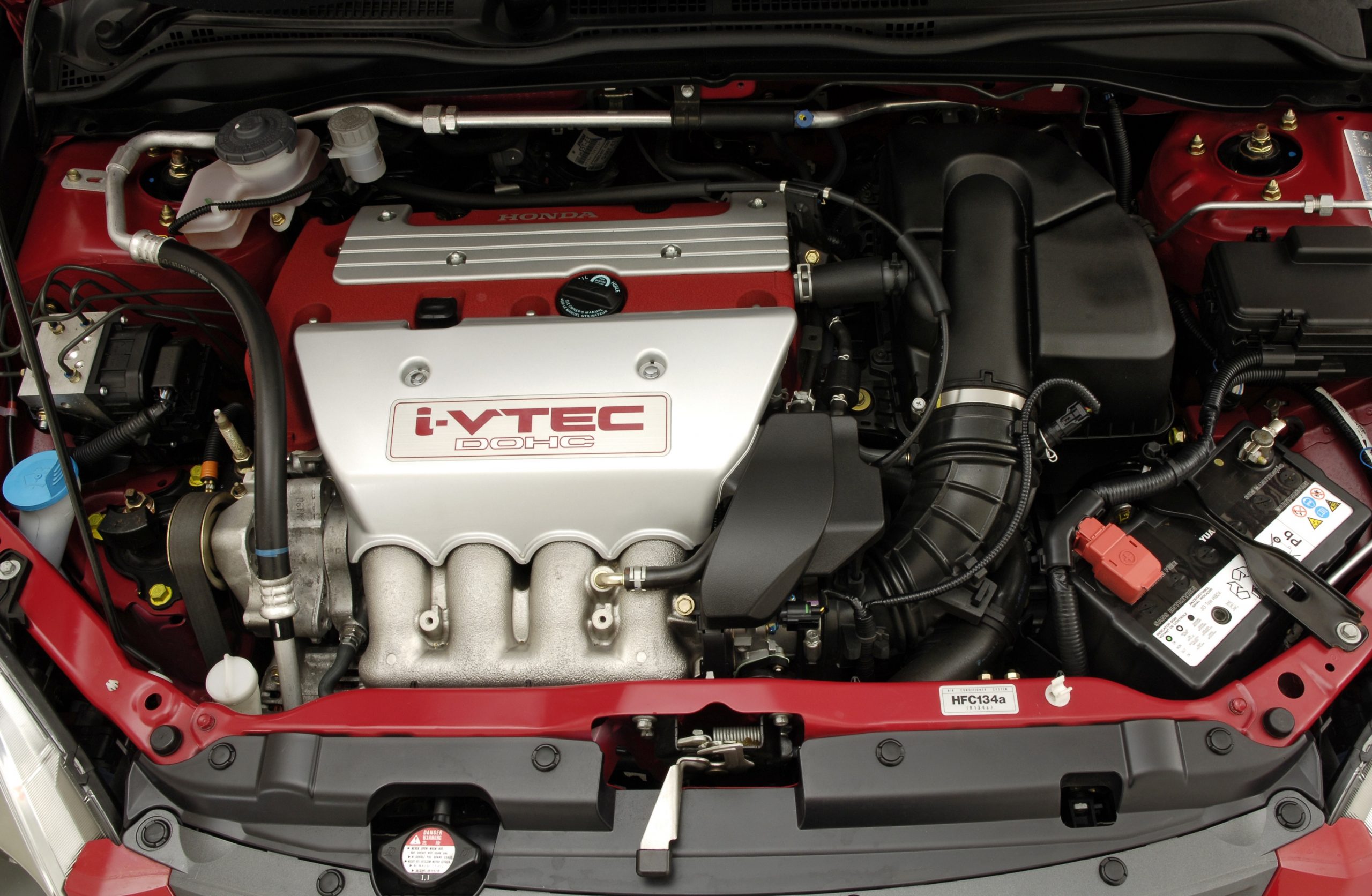The engine bay of a Honda Civic Type R in red