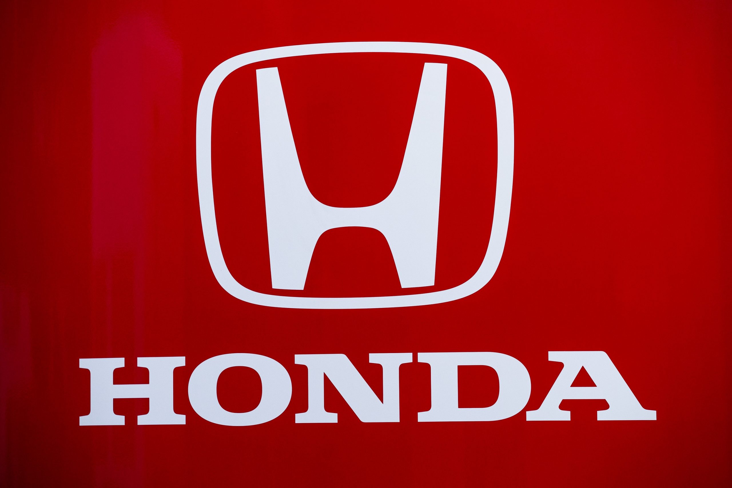 The Honda logo in white against a red background