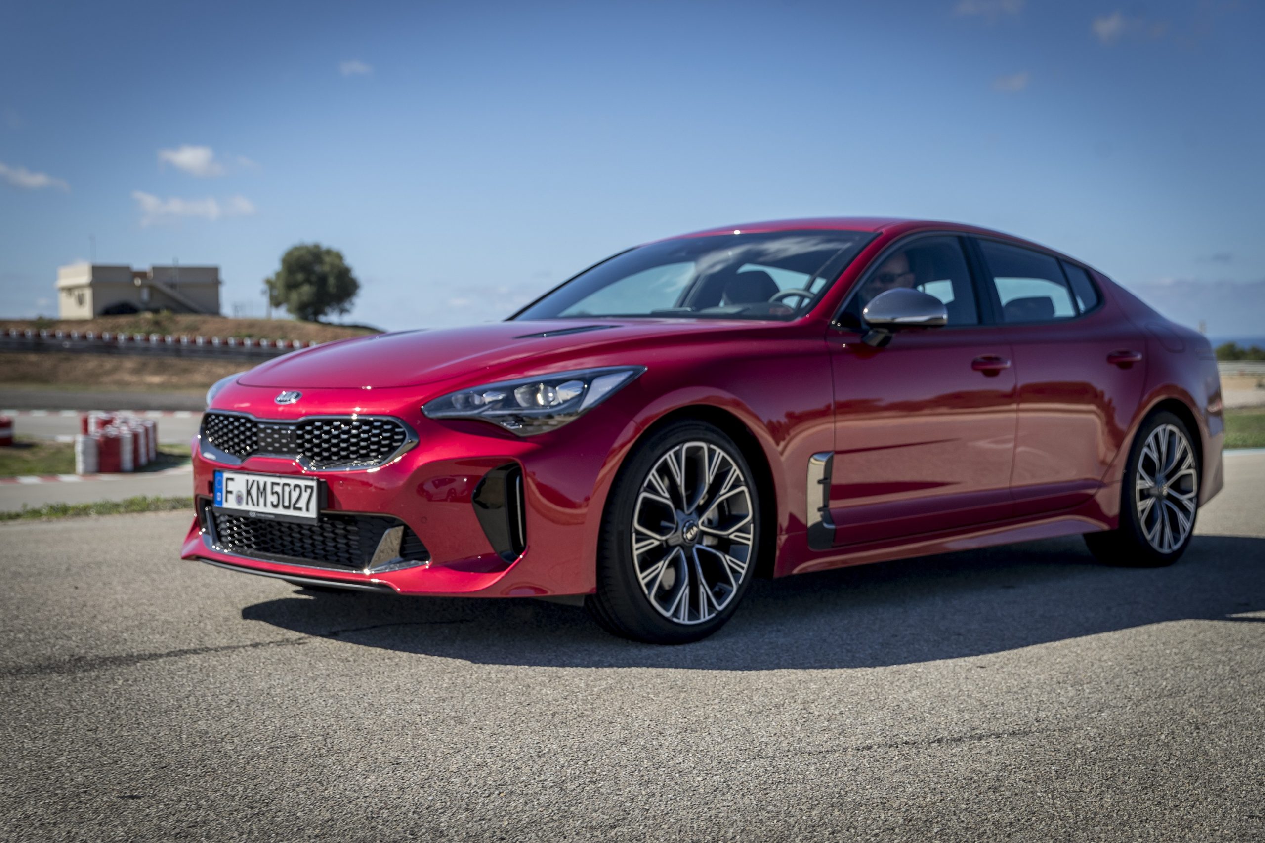 A red Kia Stinger GT shot from the front 3/4