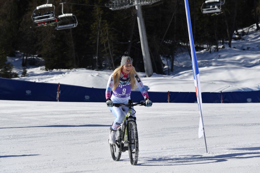 Lindsey Vonn from the USA rides an electric bike on the snow after the FIS Alpine World Cup Women's Downhill.