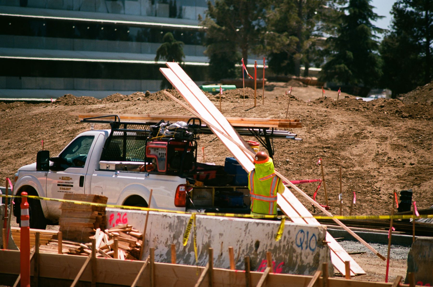 A construction worker loading up a pickup truck with equipment and materials