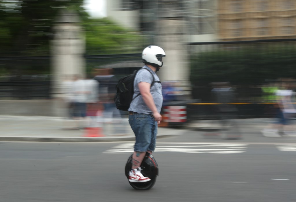 A person riding an electric unicycle in Westminster, London.