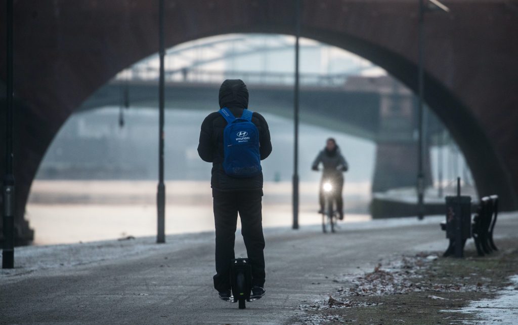 A man on an electric unicycle on the banks of the river Main in Frankfurt am Main, Germany. 