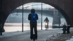 A man on an electric unicycle on the banks of the river Main in Frankfurt am Main, Germany