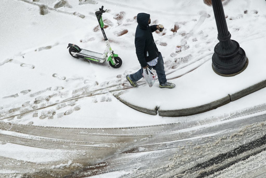 A man walks along Florida Avenue NE, in the NoMa neighborhood as a winter storm moved through the Washington, D.C., area on Thursday, February 18, 202