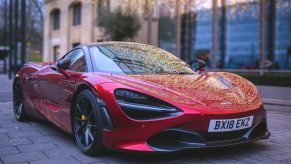 A red McLaren 720s parked up in London, shot from the front 3/4