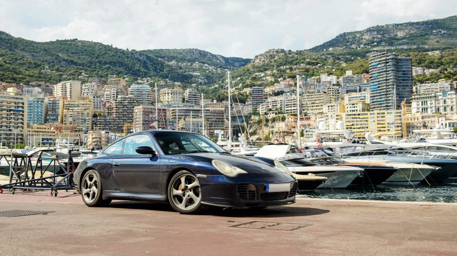 A dark blue 996 Porsche 911 on the docks in Monaco, shot from the 3/4 angle