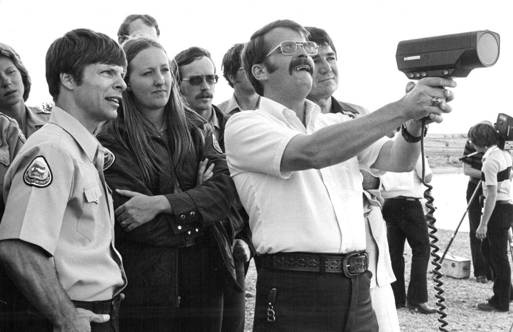  Bill Brougham, metro regional manager of the Colorado Division of Parks and Outdoor Recreation, uses radar to gauge speed of a motorboat on Cherry Creek Reservoir. 