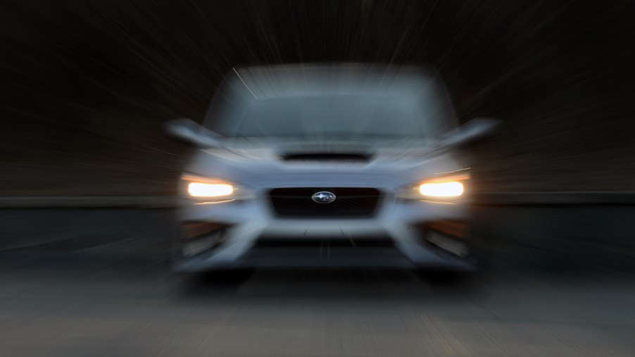 A silver Subaru WRX shot from the front with a blur effect applied to the photo