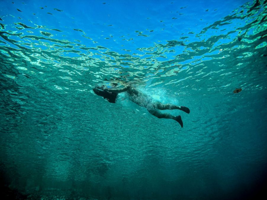 A tourist swimming with a sea scooter in Ithaca, Greece