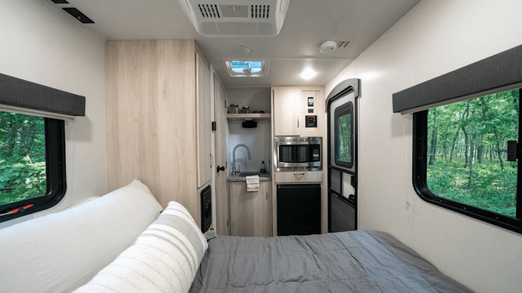 The 2022 Winnebago Hike 100 interior with bed and tiny kitchenette
