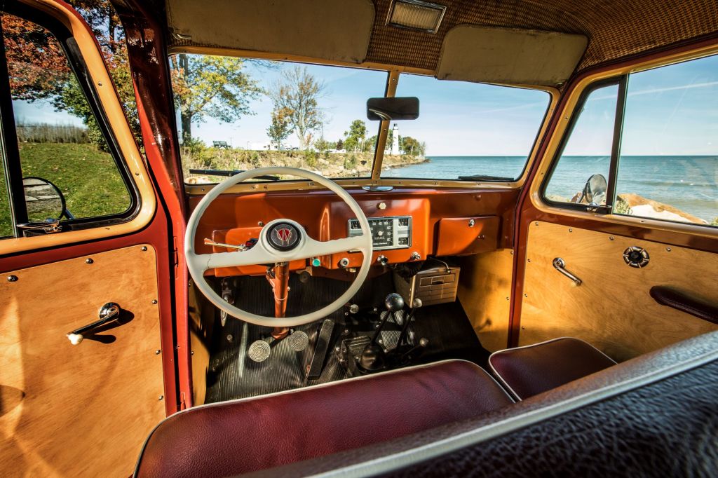 The brown-vinyl front seats, brown dashboard, and basket-weave headliner in a 1949 Willys-Overland Station Wagon