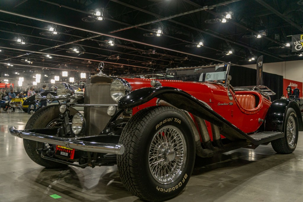 A red-and-black 1968 Excalibur SS Series I Roadster at the 2021 Chicago Mecum auction