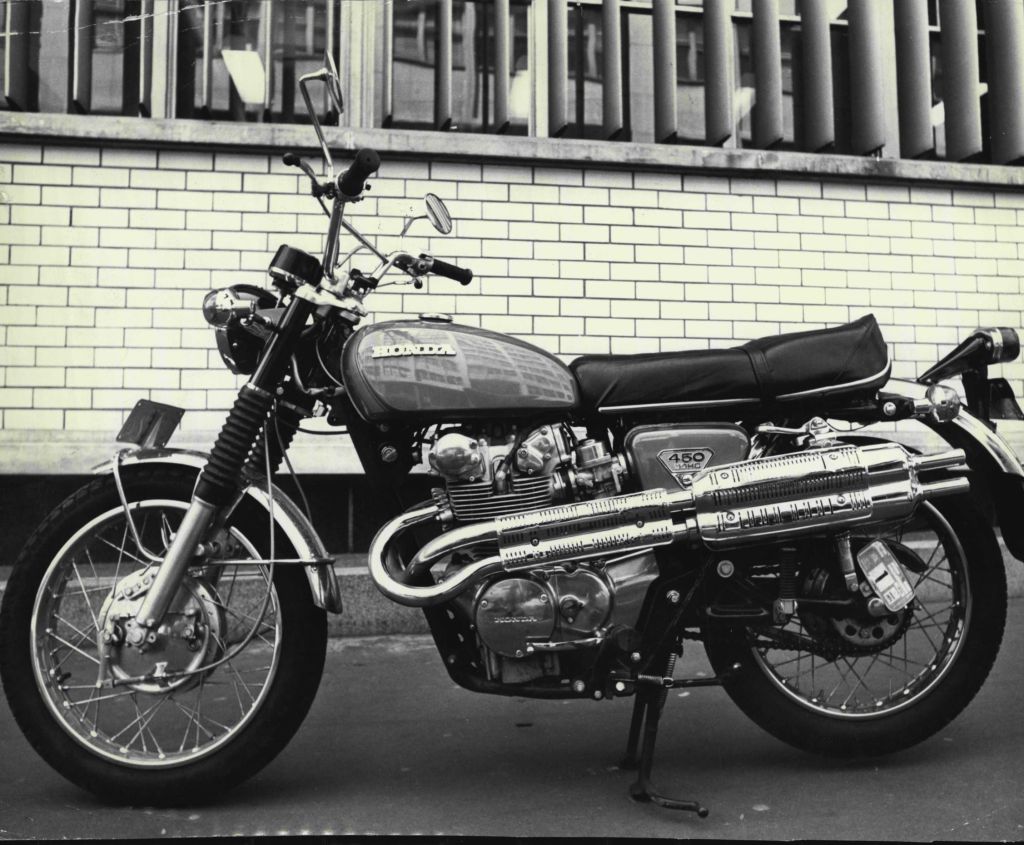 The side view of a 1970 Honda CL450 Scrambler on a city street