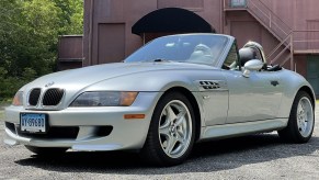 A silver 1998 BMW Z3 M Roadster in front of a red building