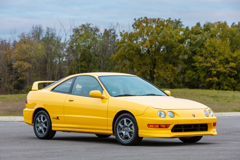A yellow 2001 Acura Integra Type R on a racetrack