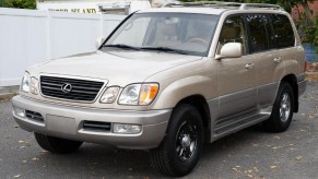 A tan-and-gray 2002 Lexus LX 470 in a parking lot