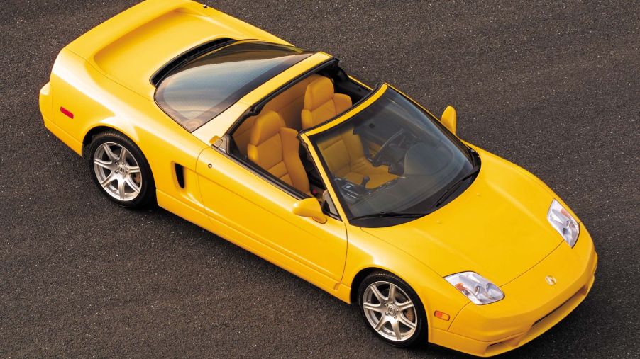 The overhead view of a yellow 2005 Acura NSX-T with its roof off