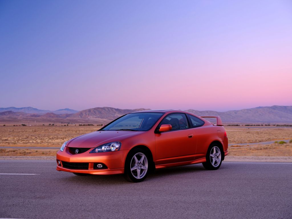 An orange 2006 Acura RSX Type S on a racetrack