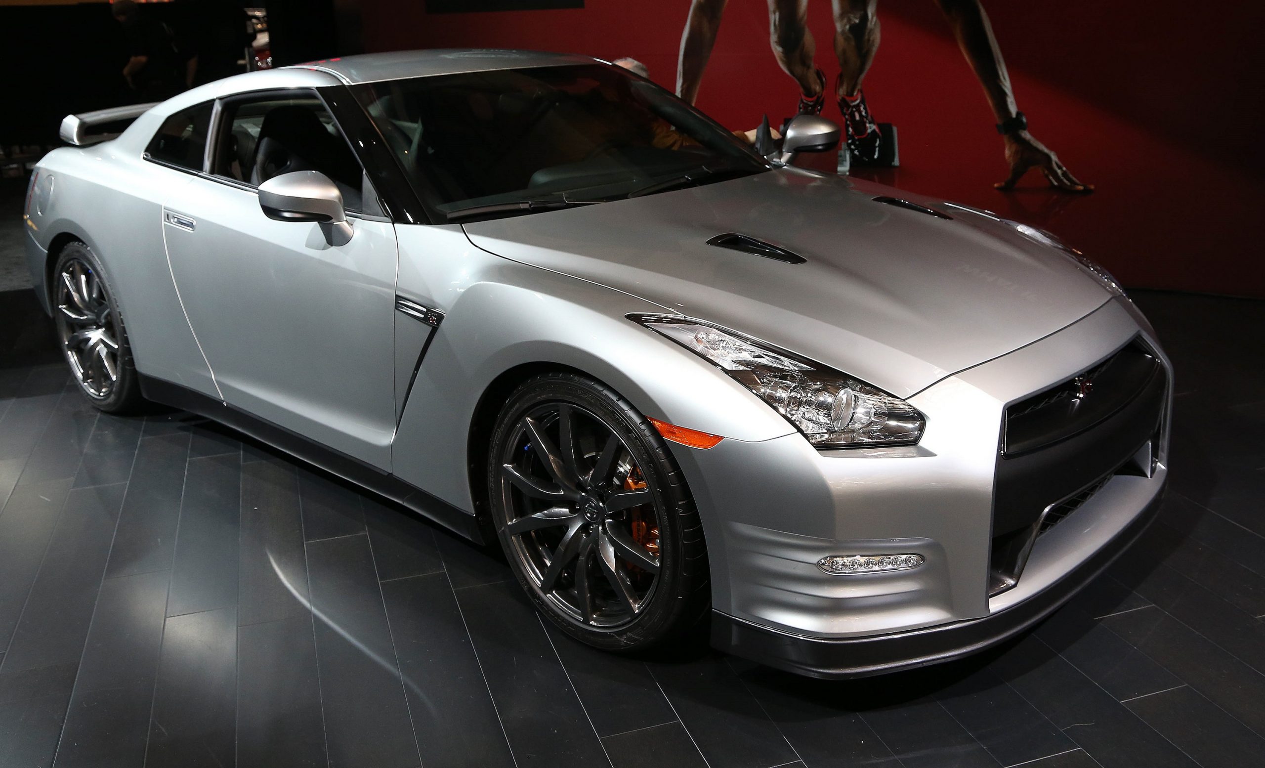 A silver Nissan GT-R shot from the high 3/4 angle at an auto show