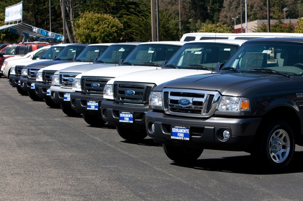 a dealer's lot loaded with 2011 Ford Ranger pickup truck models, the last generation before its discontinuation.