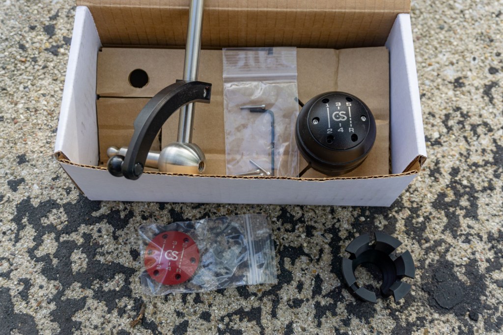 A 2013 Fiat 500 Abarth CravenSpeed short-throw shifter kit with retaining clip and accessory cover