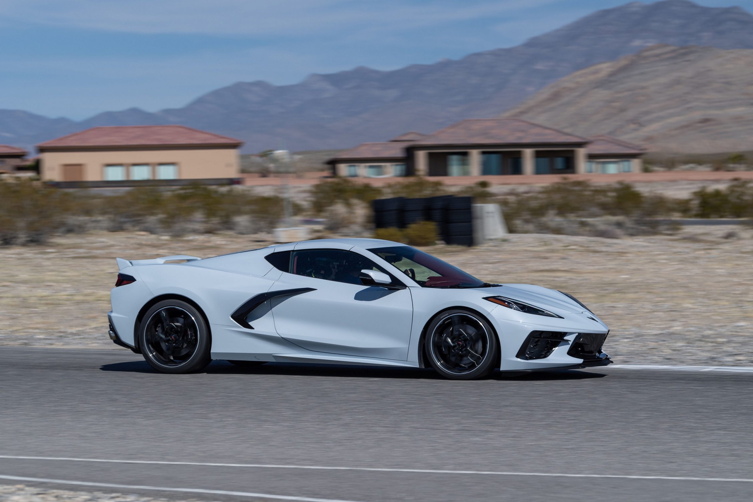 A white Chevrolet Corvette, the latest bargain sports car from Chevrolet, shot in profile on a race track