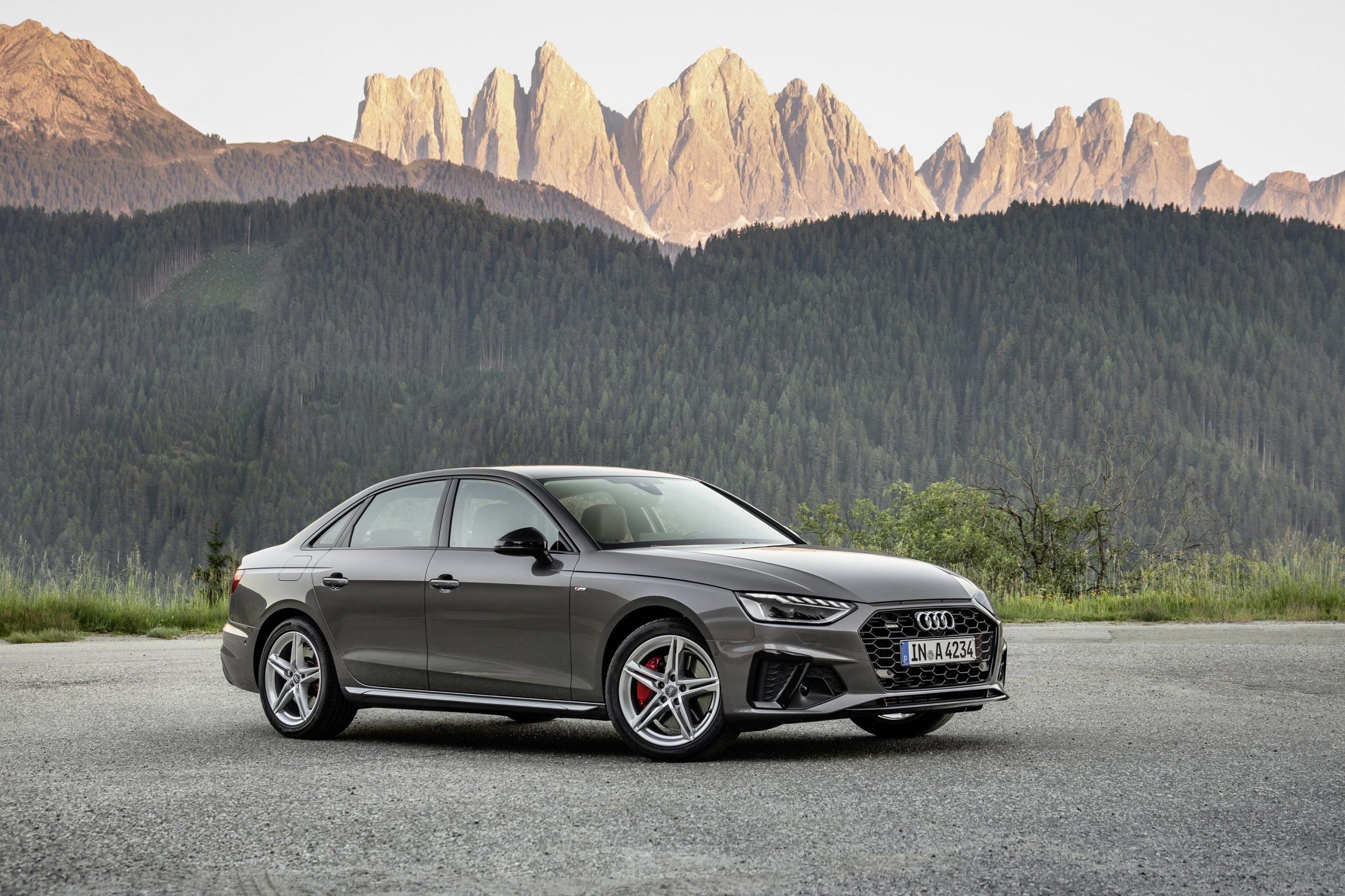 A grey 2021 Audi S4 shot from the front 3/4 on a mountain pass