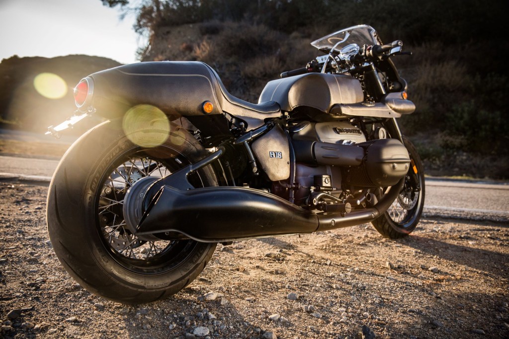 The rear 3/4 view of the bronze-and-black 2021 BMW R 18 'The Wal' by Shinya Kimura on a California mountain road