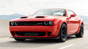 The 2021 Dodge Challenger SRT Super Stock muscle car with a Dual Snorkel Hood parked on a highway