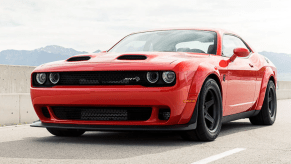 The 2021 Dodge Challenger SRT Super Stock muscle car with a Dual Snorkel Hood parked on a highway