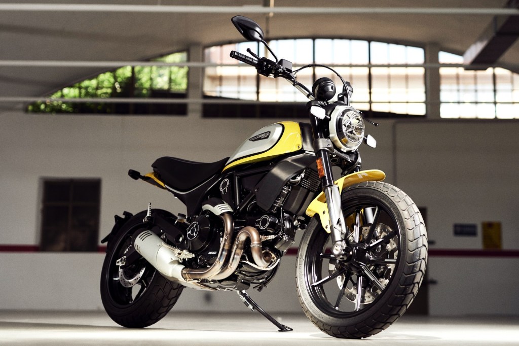 A yellow-black-and-silver 2021 Ducati Scrambler Icon in a garage