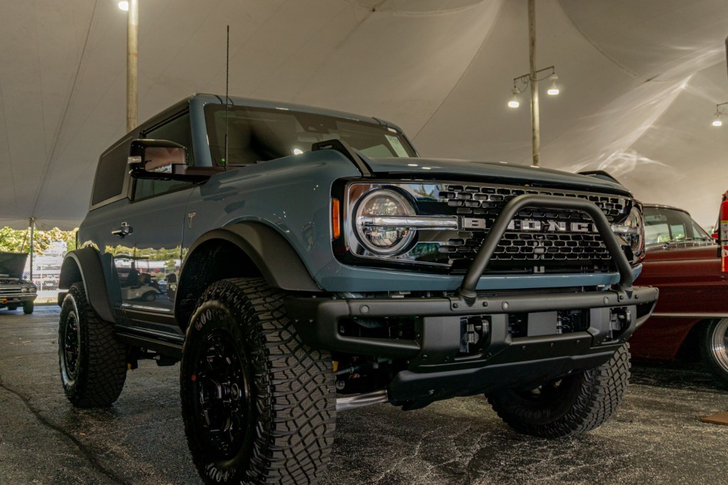 A blue 2021 Ford Bronco First Edition 2-Door underneath a tent at the 2021 Mecum Chicago auction