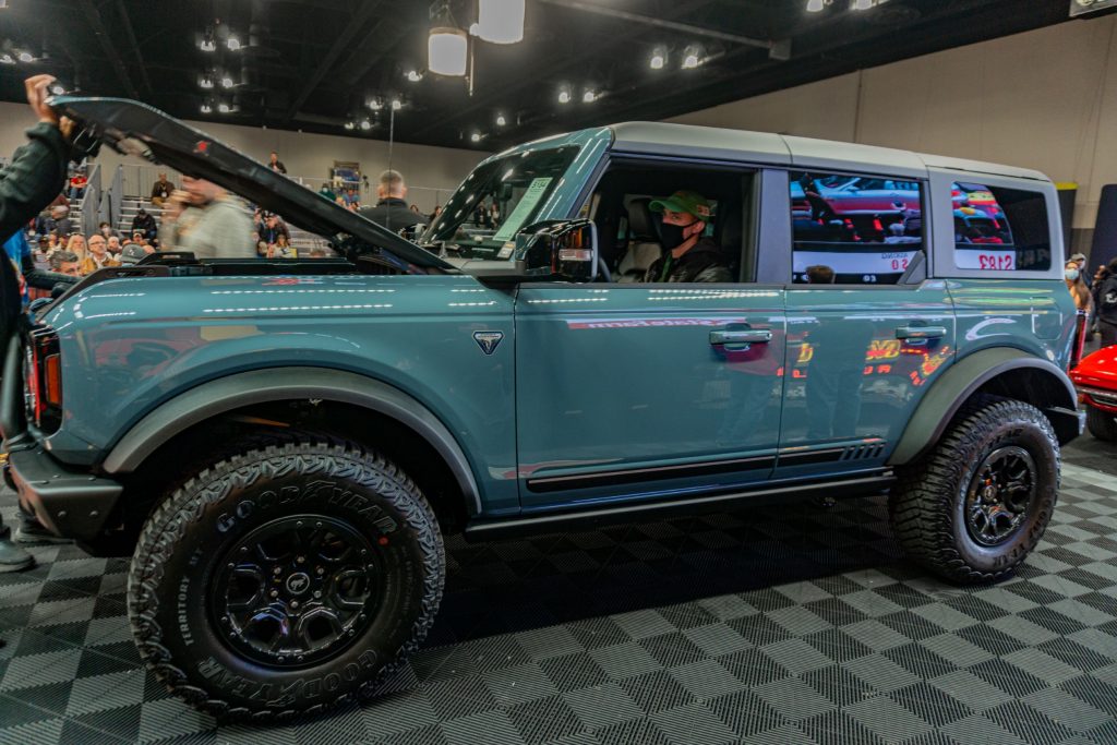 The side view of a blue 2021 Ford Bronco First Edition 4-Door on the 2021 Mecum Chicago auction floor